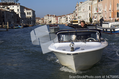 Image of Man in a water taxi in Venice