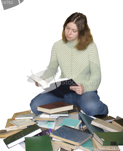 Image of Student girl reading on the heap of books