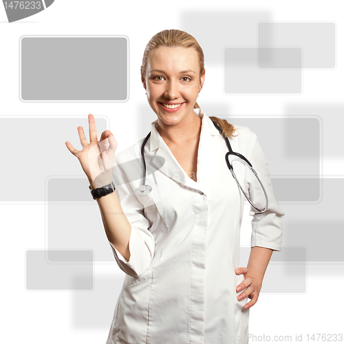 Image of young doctor woman shows ok