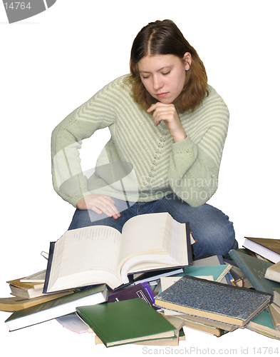 Image of Student girl reading on the heap of books