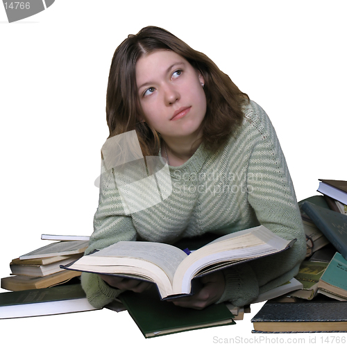 Image of Student girl reading on the heap of books