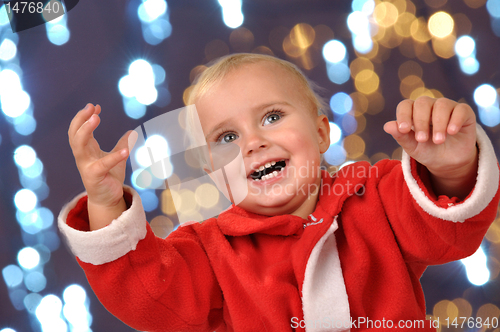 Image of happy Christmas baby with hands raised