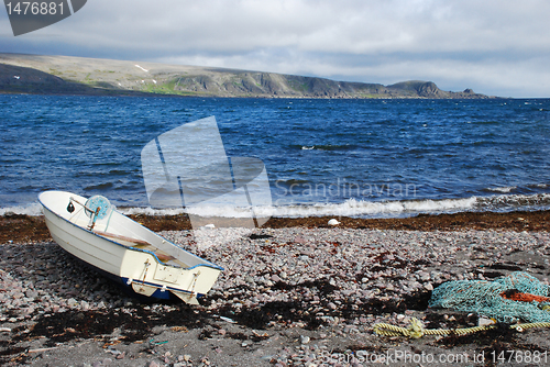 Image of Lonaly boat at Barebtz sea cost close to abandoned fishing villa