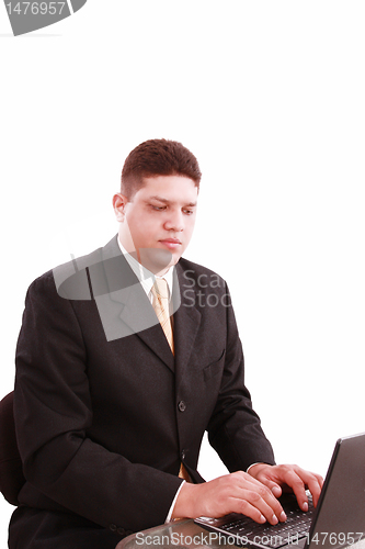 Image of business man on a laptop in an office