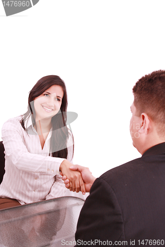 Image of Two businesspeople, or business person and client handshaking at