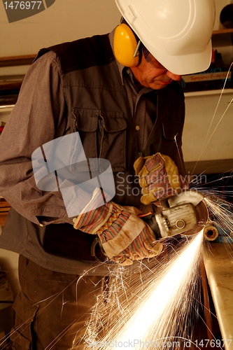 Image of Worker with angle grinder