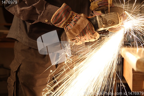 Image of Worker with angle grinder only hands