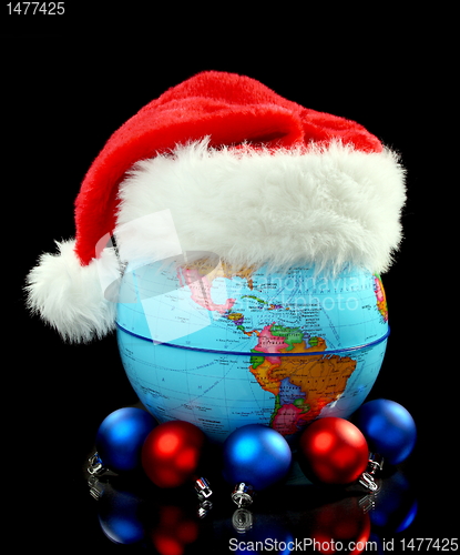 Image of Globe Santa hat and Christmas balls.