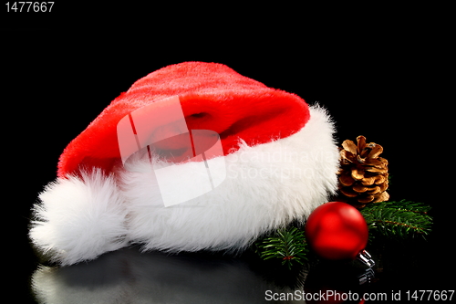 Image of Santa's hat, Christmas ball and pine cone.