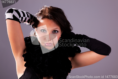 Image of Young and attractive woman looking to camera, with hands holding hair