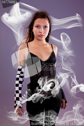 Image of young and beautiful woman, with smoke effects