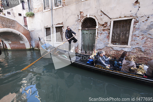 Image of Gondolier in a narrow canal