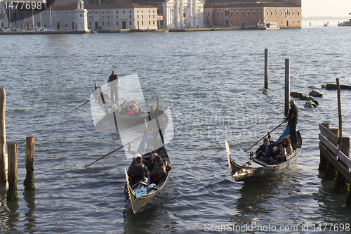 Image of Three gondolas with passengers.