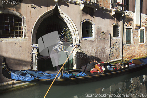 Image of Gondolier driving in a narrow canal