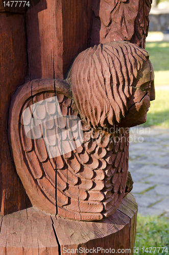 Image of Cracks in wooden sculpture head closeup.