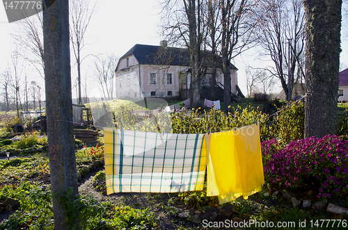 Image of Old house with slate roof. Laundry drying on rope.