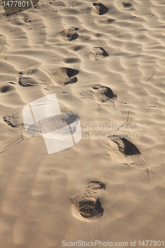 Image of Human trace of a foot on yellow sand