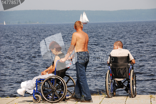 Image of Disabled people in wheelchairs on the embankment