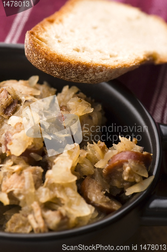 Image of traditional polish sauerkraut (bigos) with mushrooms and plums