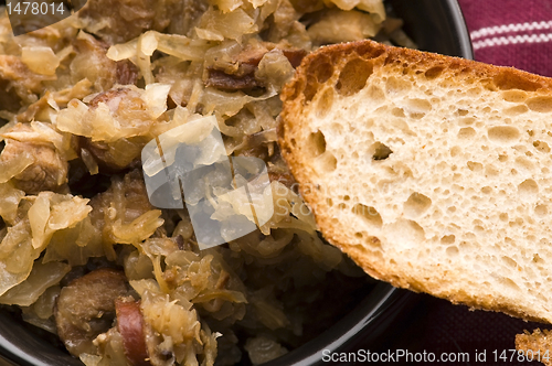 Image of traditional polish sauerkraut (bigos) with mushrooms and plums