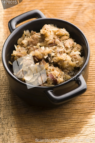 Image of traditional polish sauerkraut (bigos) with mushrooms and plums