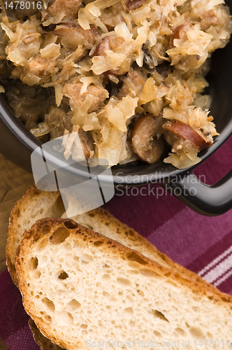 Image of traditional polish sauerkraut (bigos) with mushrooms and plums