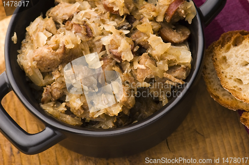 Image of traditional polish sauerkraut (bigos) with mushrooms and plums