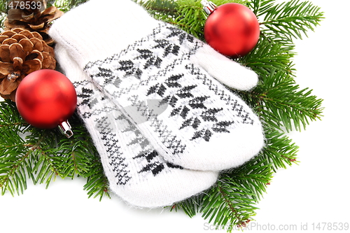 Image of Christmas still life with mittens and balls.