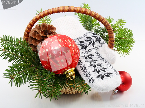 Image of Basket with Christmas tree,balls and pine cones.