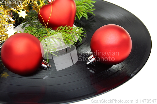 Image of Christmas still life with a vinyl disc and balls.
