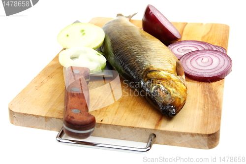 Image of Smoked herring on the kitchen board.