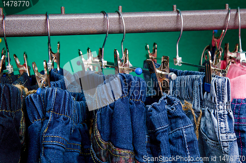 Image of Denim pants on a hanger for children in the store