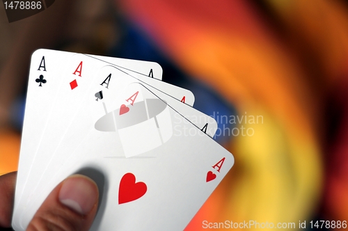Image of hand holding four aces