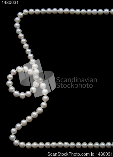 Image of White pearls on the black velvet  background