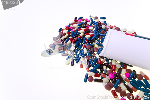 Image of pills spilling out of container 