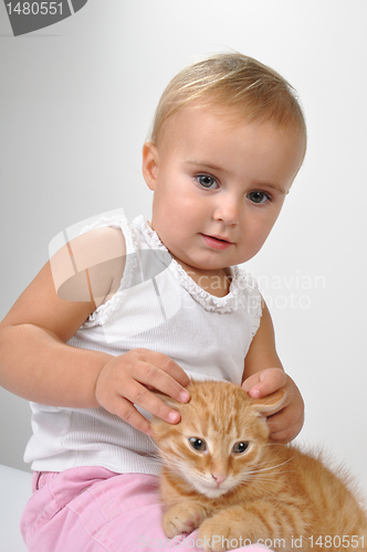 Image of baby playing with a kitten