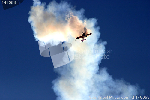 Image of Plane in the cloud of smoke at the European Aerobatic Championship. Highly contrasted and toned, seems like a plane crash.