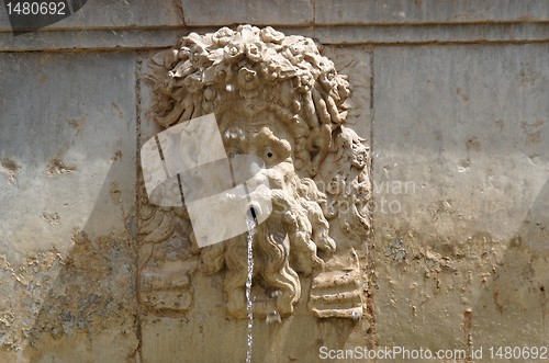 Image of Funny mascaron face on fountain in Alhambra, Granada, Spain
