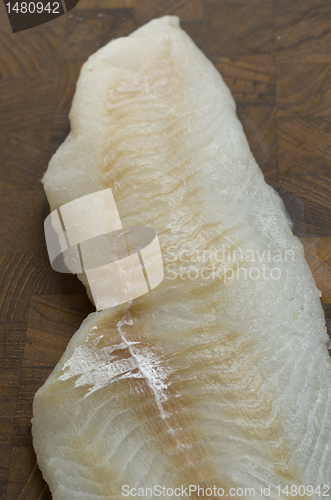 Image of Raw Cod on a wooden butcher 