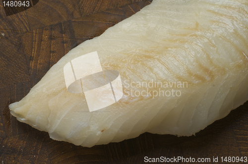 Image of Raw Cod on a wooden butcher 