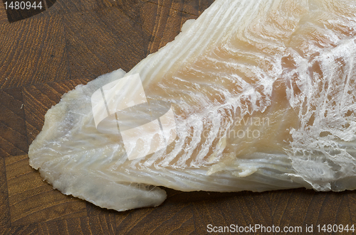 Image of Raw Cod on a wooden butcher 