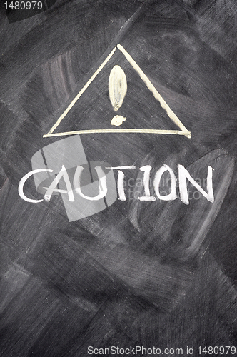 Image of Caution written on blackboard