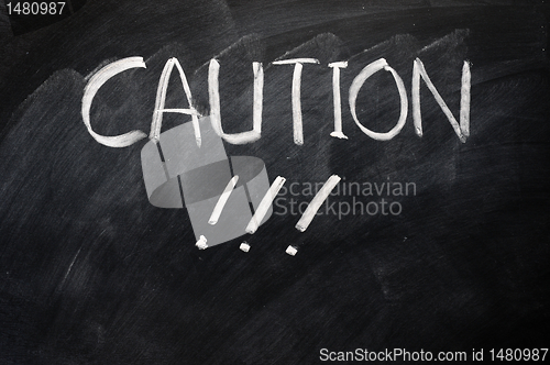 Image of Caution written on blackboard