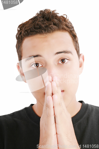 Image of Young cute, handsome and thoughtful man with his hands 