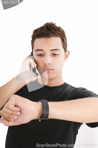 Image of Portrait of a busy young male using mobile phone and looking at 