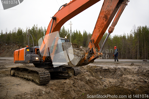 Image of Backhoe digging trench