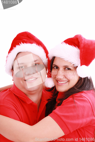 Image of Young happy couple near with Santa hats. Isolated over white bac