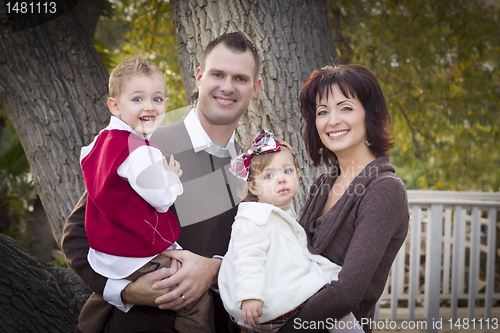 Image of Young Attractive Parents and Children Portrait in Park