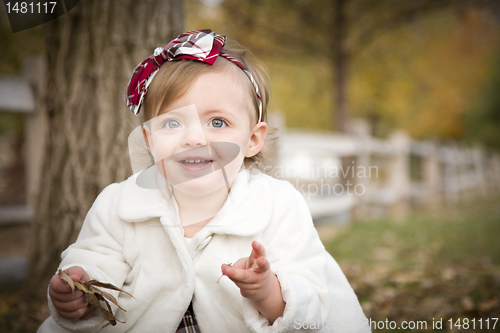 Image of Adorable Baby Girl Playing in Park