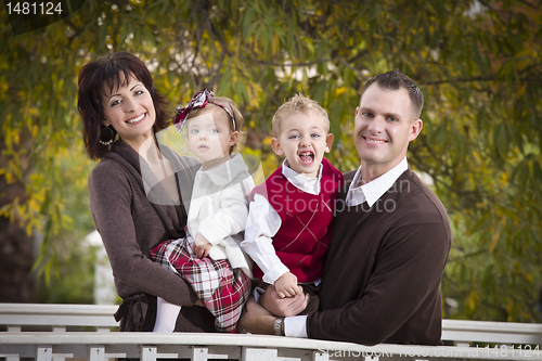 Image of Young Attractive Parents and Children Portrait in Park